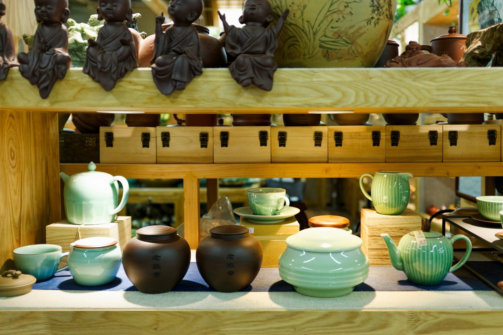 A display of pottery on a wooden shelf